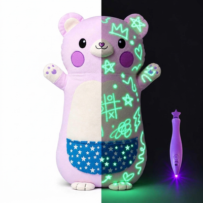 Glow-in-the-dark bear plush, half in light and half glowing in the dark, with the light pen